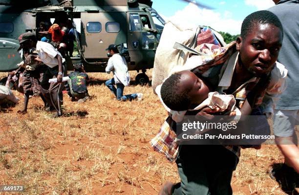 South African army helicopter lands at Chibuto airfield to rescue families from the flooded Limpopo river March 3, 2000 in Mozambique. The country...