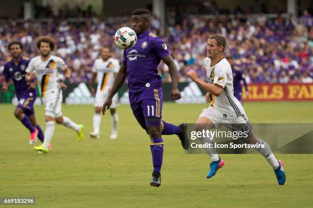 Orlando City SC forward Carlos Rivas gets the ball and is chased by Los Angeles Galaxy defender Nathan Smith during the soccer match between the LA...