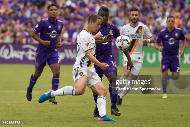 Los Angeles Galaxy defender Nathan Smith and Orlando City SC forward Carlos Rivas go after the ball during the soccer match between the LA Galaxy and...