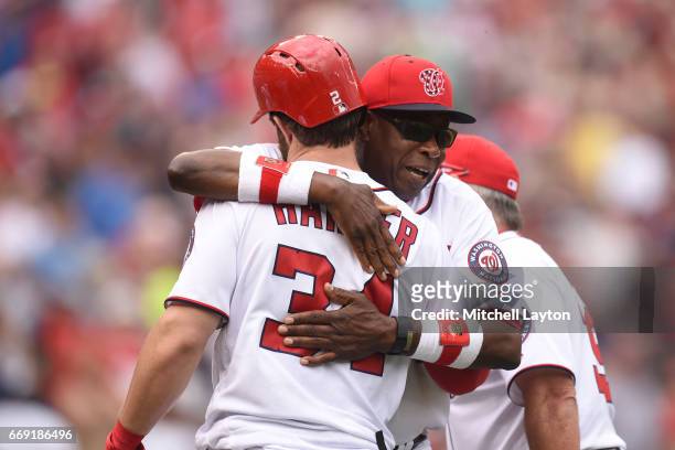 Bryce Harper of the Washington Nationals celebrate hitting a game winning three run home run in the ninth inning with manager Dusty Baker#12 after a...