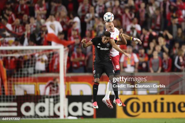 Aurelien Collin of New York Red Bulls heads clear while challenged by Jose Guillermo Ortiz of D.C. United during the New York Red Bulls Vs D.C....