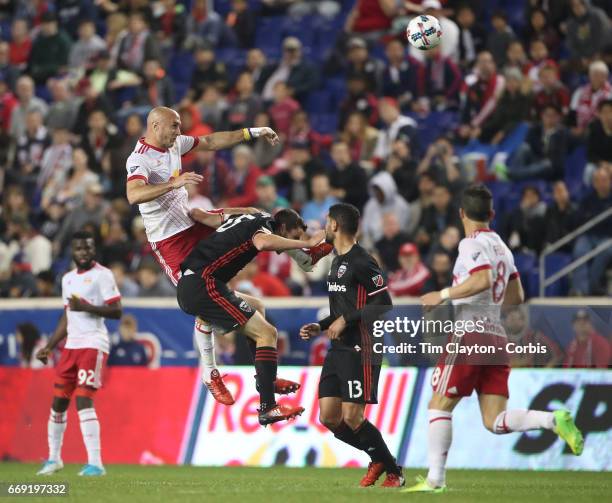 Aurelien Collin of New York Red Bulls heads clear while challenged by Steve Birnbaum of D.C. United during the New York Red Bulls Vs D.C. United MLS...