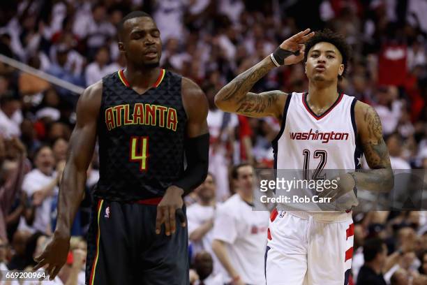 Kelly Oubre Jr. #12 of the Washington Wizards celebrates after hitting a three pointer in front of Paul Millsap of the Atlanta Hawks in the second...