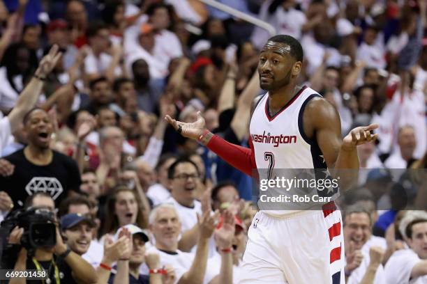 John Wall of the Washington Wizards celebrates after hitting a three pointer in the second half of the Wizards 114-107 win over the Atlanta Hawks in...