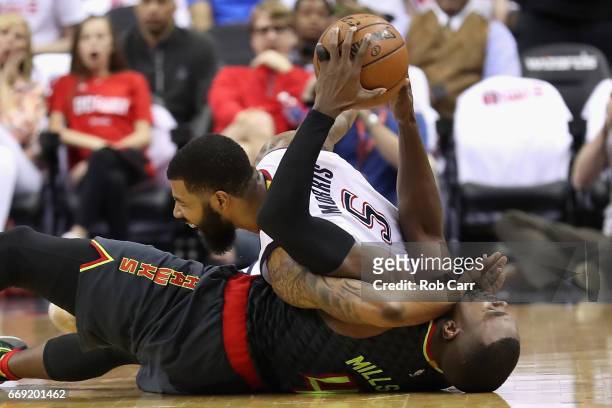 Markieff Morris of the Washington Wizards and Paul Millsap of the Atlanta Hawks go after a loose ball in the first half in Game One of the Eastern...