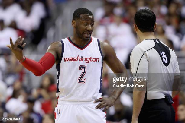 John Wall of the Washington Wizards talks with an official in the first half against the Atlanta Hawks in Game One of the Eastern Conference...