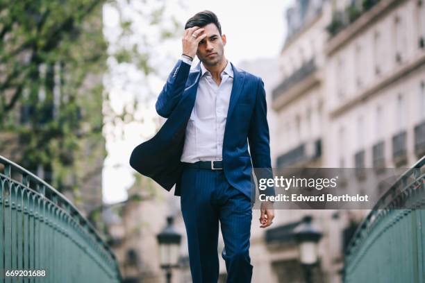 Anil Brancaleoni, Youtube personality and digital influencer WaRTeK, wears a Lanieri blue suit, a Boggi white shirt, Doucal's shoes, and a bracelet...