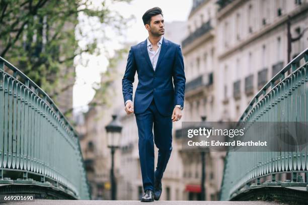 Anil Brancaleoni, Youtube personality and digital influencer WaRTeK, wears a Lanieri blue suit, a Boggi white shirt, Doucal's shoes, and a bracelet...