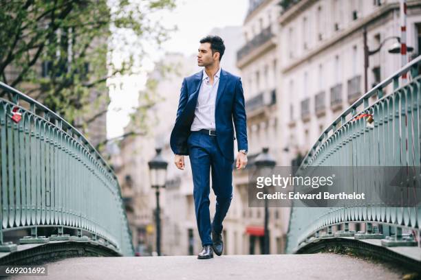 Anil Brancaleoni, Youtube personality and digital influencer WaRTeK, wears a Lanieri blue suit, a Boggi white shirt, Doucal's shoes, and a bracelet...