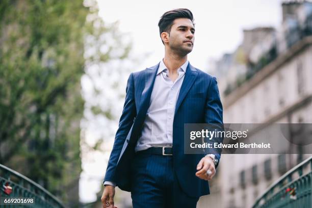 Anil Brancaleoni, Youtube personality and digital influencer WaRTeK, wears a Lanieri blue suit, a Boggi white shirt, Doucal's shoes, and a bracelet...