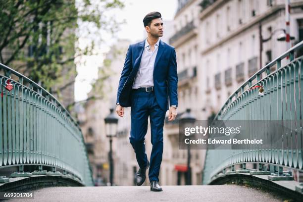 Anil Brancaleoni, Youtube personality and digital influencer WaRTeK, wears a Lanieri blue suit, a Boggi white shirt, Doucal's shoes, and a bracelet...