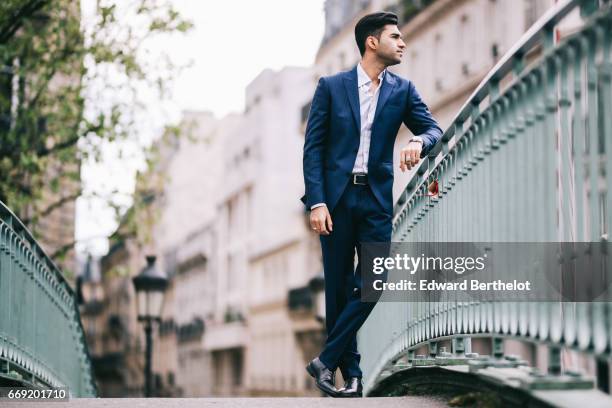 Anil Brancaleoni, Youtube personality and digital influencer WaRTeK, wears a Lanieri blue suit, a Boggi white shirt, Doucal's shoes, and a bracelet...