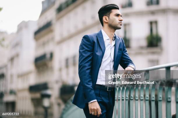 Anil Brancaleoni, Youtube personality and digital influencer WaRTeK, wears a Lanieri blue suit, a Boggi white shirt, Doucal's shoes, and a bracelet...