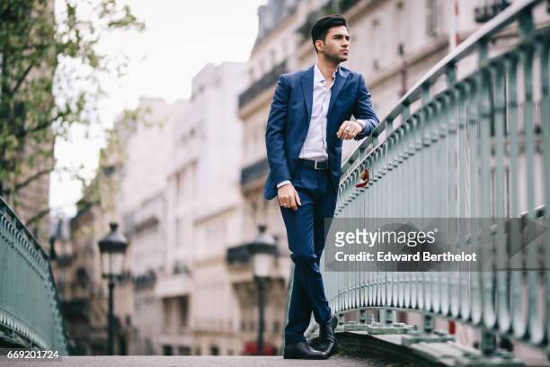 Anil Brancaleoni, Youtube personality and digital influencer WaRTeK, wears a Lanieri blue suit, a Boggi white shirt, Doucal's shoes, and a bracelet...
