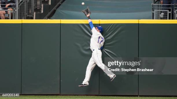 Rightfielder Mitch Haniger of the Seattle Mariners catches a ball hit by Joey Gallo of the Texas Rangers at the outfield wall during the eighth...