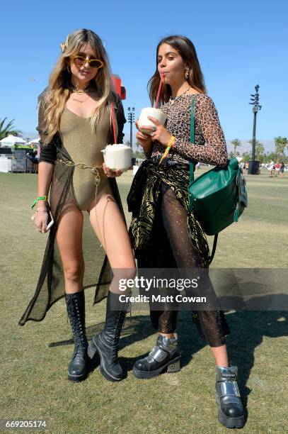 Festivalgoers pose with a coconut drink during Coachella Valley Music And Arts Festival at Empire Polo Club on April 16, 2017 in Indio, California.