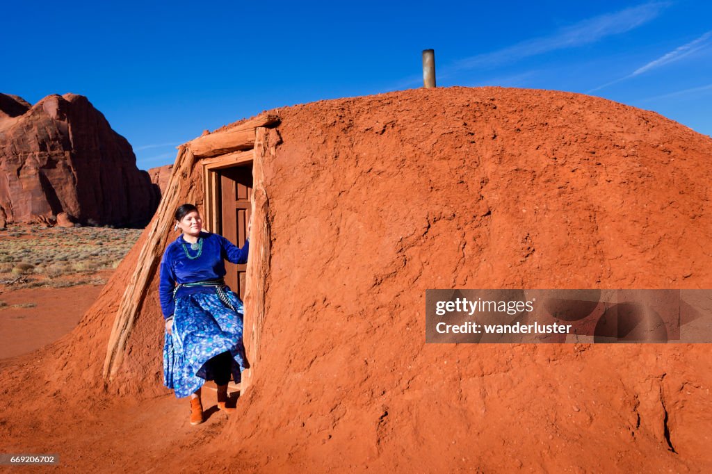 Beautiful young Navajo woman outside her hogan