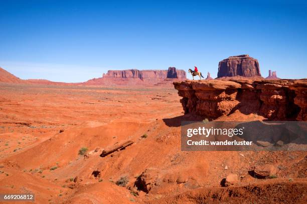 navajo man on horse at john ford's point monument valley - navajo hogan stock pictures, royalty-free photos & images