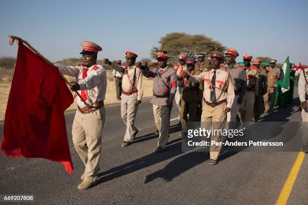 Herero groups parade in traditional military uniforms during a march when commemorating fallen chiefs killed in battles with Germans on August 12,...