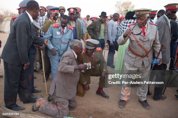 Herero elder spits water in the faces of newly arrived Herero women during a march when commemorating fallen chiefs killed in battles with Germans on...