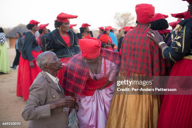 Herero elder spits water in the faces of newly arrived Herero women during a march when commemorating fallen chiefs killed in battles with Germans on...