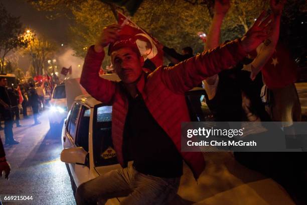 People celebrate the 'Evet' vote result outside AK Party headquarters on April 16, 2017 in Istanbul, Turkey. According to unofficial results 51.21%...