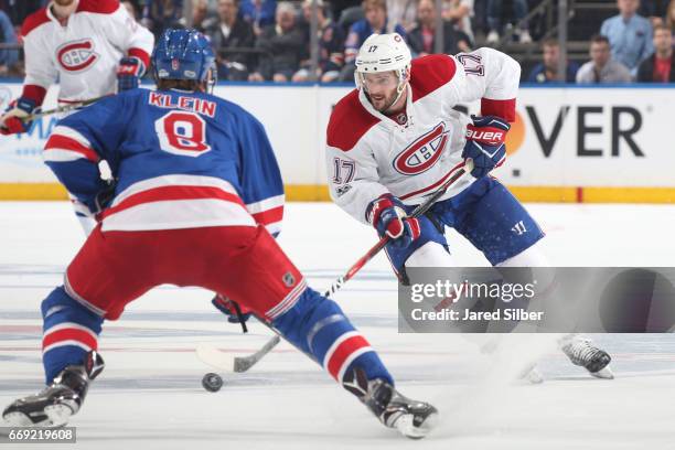 Torrey Mitchell of the Montreal Canadiens skates with the puck against Kevin Klein of the New York Rangers in Game Three of the Eastern Conference...