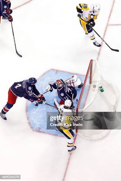 Evgeni Malkin of the Pittsburgh Penguins watches as teammate Jake Guentzel beats Sergei Bobrovsky of the Columbus Blue Jackets for a goal during the...