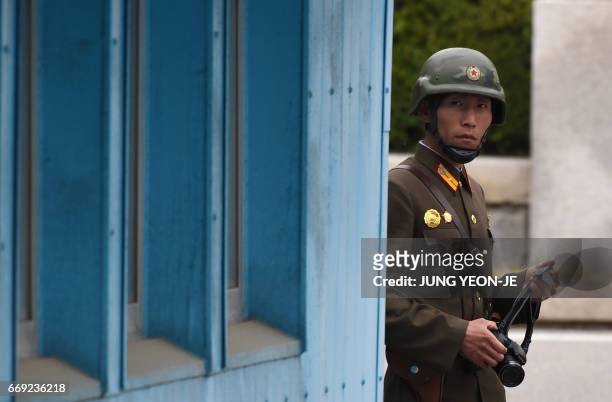 North Korean soldier looks at the South side while US Vice President Mike Pence visits the truce village of Panmunjom in the Demilitarized Zone on...