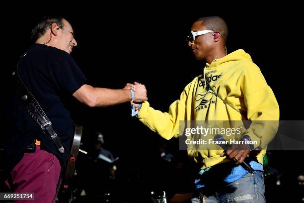 Hans Zimmer and Pharrell Williams embrace onstage at the Outdoor Theatre during day 3 of the Coachella Valley Music And Arts Festival at the Empire...