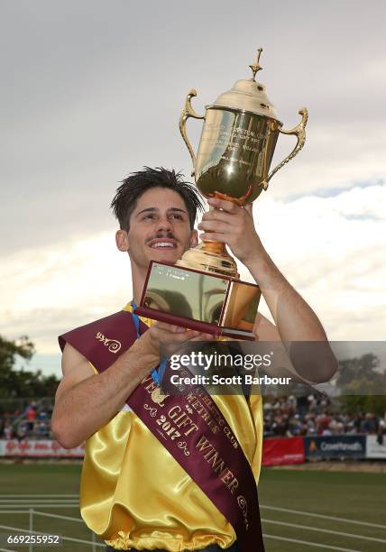 Matthew Rizzo celebrates with the trophy after winning the 2017 Stawell Athletic Club Stawell Gift - 120m Final race during the 2017 Stawell Gift on...