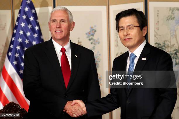 Vice President Mike Pence, left, shakes hands with Hwang Kyo-ahn, South Korea's acting president and prime minister, ahead of a meeting in Seoul, on...