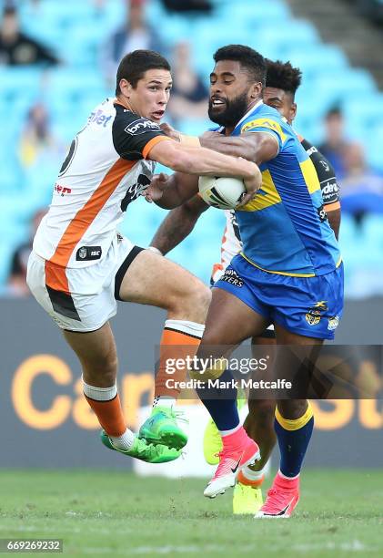 Mitch Moses of the Tigers is tackled by Michael Jennings of the Eels during the round seven NRL match between the Parramatta Eels and the Wests...