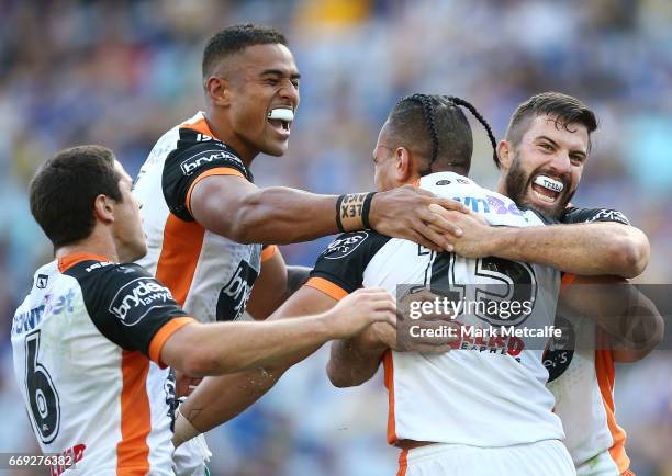 Sauaso Sue of the Tigers celebrates scoring a try with team mates during the round seven NRL match between the Parramatta Eels and the Wests Tigers...