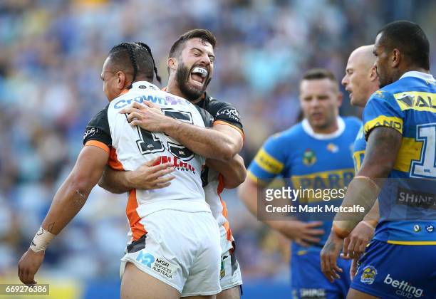 Sauaso Sue of the Tigers celebrates scoring a try with team mates during the round seven NRL match between the Parramatta Eels and the Wests Tigers...