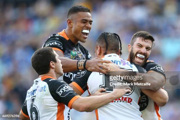 Sauaso Sue of the Tigers celebrates scoring a try with team mates during the round seven NRL match between the Parramatta Eels and the Wests Tigers...