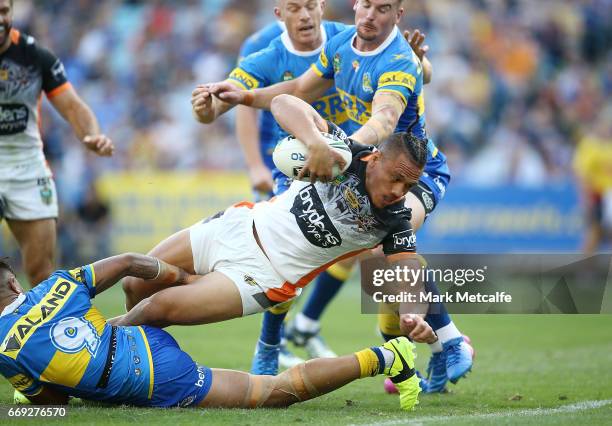 Sauaso Sue of the Tigers scores a try during the round seven NRL match between the Parramatta Eels and the Wests Tigers at ANZ Stadium on April 17,...