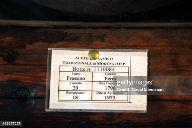 Sign under an old 20-liter cask records that it was made from Ash Tree wood in the year 1790, and was filled with 18 liters of balsamic vinegar in...