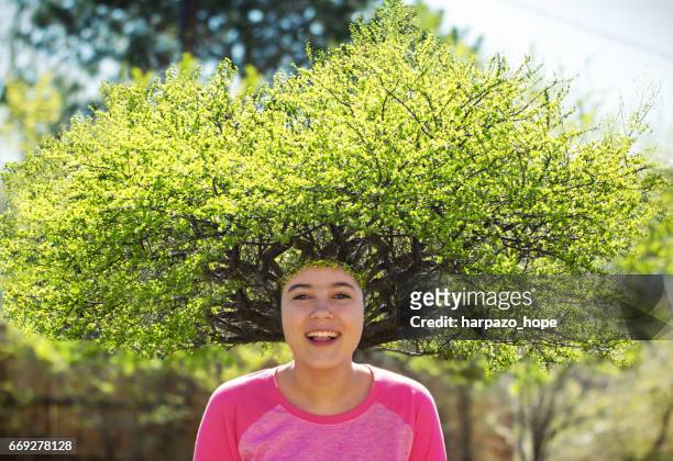smiling girl with a tree for hair. - young leafs stockfoto's en -beelden