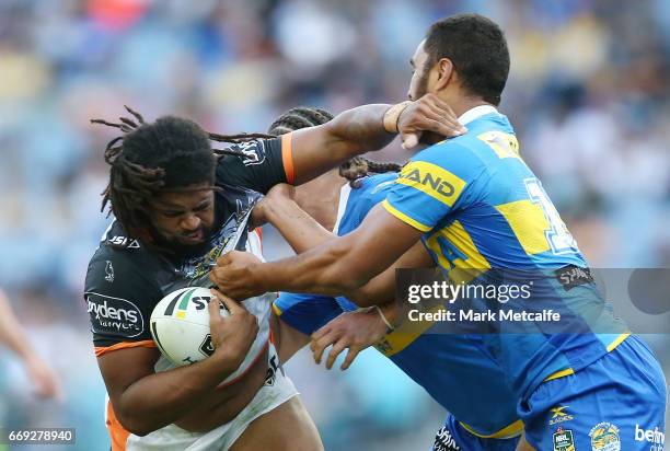 Jamal Idris of the Tigers is tackled during the round seven NRL match between the Parramatta Eels and the Wests Tigers at ANZ Stadium on April 17,...