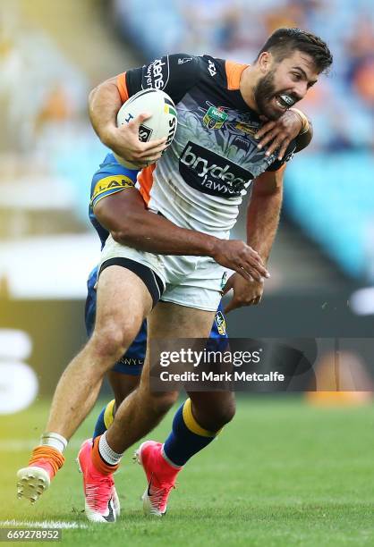 James Tedesco of the Tigers is tackled during the round seven NRL match between the Parramatta Eels and the Wests Tigers at ANZ Stadium on April 17,...