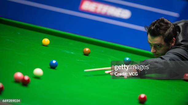 Ronnie O'Sullivan of England plays a shot during his first round match against Gary Wilson of England on day two of Betfred World Championship 2017...