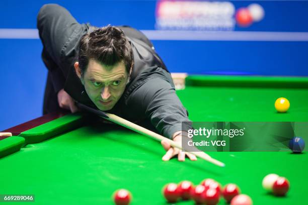 Ronnie O'Sullivan of England plays a shot during his first round match against Gary Wilson of England on day two of Betfred World Championship 2017...