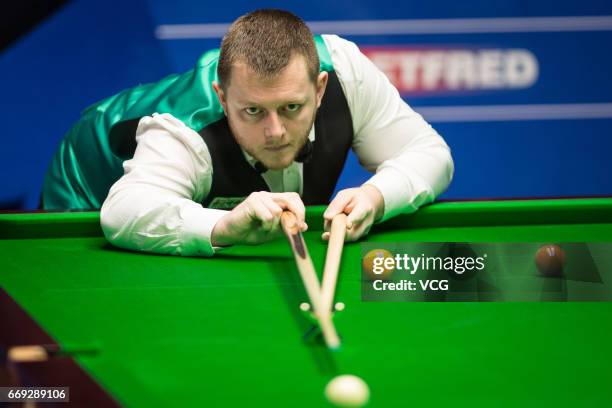 Mark Allen of Northern Ireland plays a shot during his first round match against Jimmy Robertson of England on day two of Betfred World Championship...