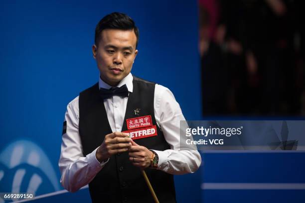 Marco Fu of Hong Kong reacts during his first round match against Luca Brecel of Belgium on day two of Betfred World Championship 2017 at Crucible...