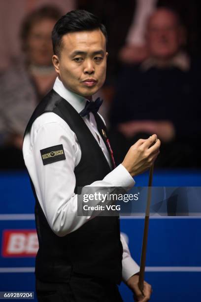 Marco Fu of Hong Kong reacts during his first round match against Luca Brecel of Belgium on day two of Betfred World Championship 2017 at Crucible...