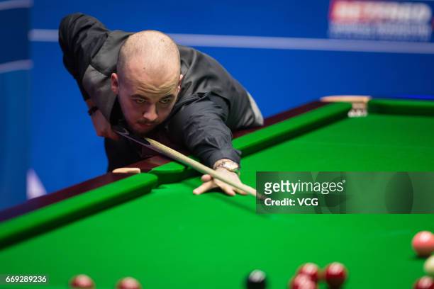 Luca Brecel of Belgium plays a shot during his first round match against Marco Fu of Hong Kong on day two of Betfred World Championship 2017 at...