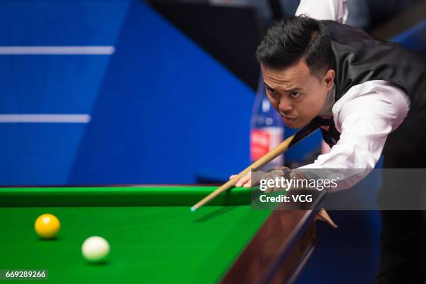 Marco Fu of Hong Kong plays a shot during his first round match against Luca Brecel of Belgium on day two of Betfred World Championship 2017 at...