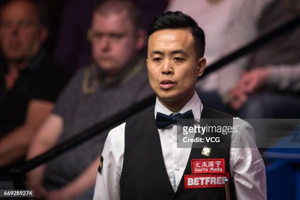 Marco Fu of Hong Kong reacts during his first round match against Luca Brecel of Belgium on day two of Betfred World Championship 2017 at Crucible...