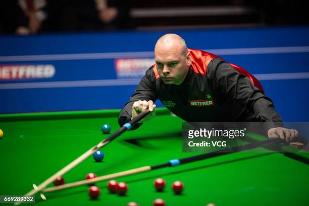 Stuart Bingham of England plays a shot during his first round match against Peter Ebdon of England on day two of Betfred World Championship 2017 at...
